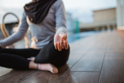 Low section of woman doing yoga