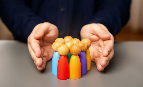 Midsection of man with pills on table