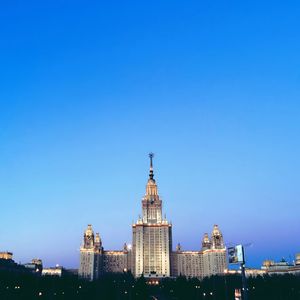 View of buildings against clear blue sky