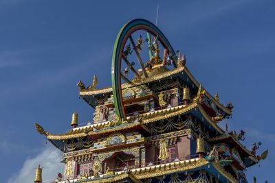 Low angle view of temple and building against sky