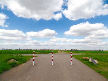 People on countryside landscape against cloudy sky