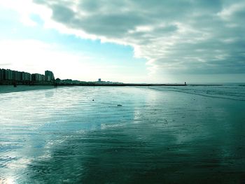 Scenic view of sea against cloudy sky