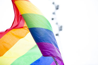 Close-up of multi colored flag against white background