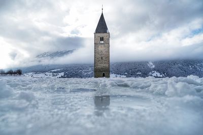 Clock tower against sky during winter