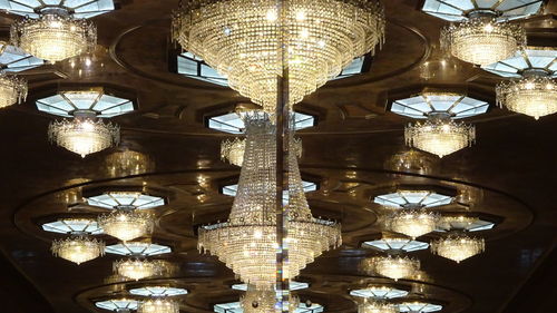 Low angle view of illuminated chandelier in building