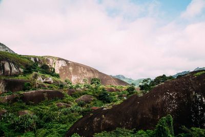 Scenic view of mountains against cloudy sky