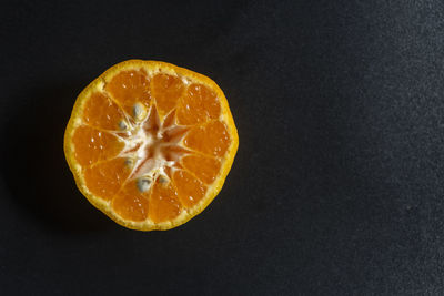 Close-up of orange slices on black background