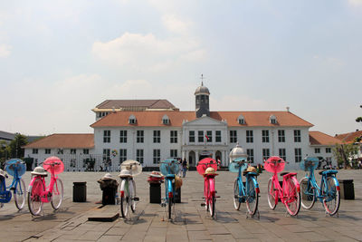 People on street against buildings in city