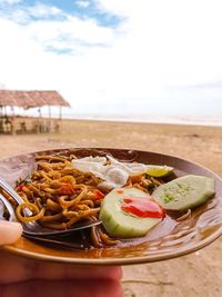Close-up of food in plate on table against sky