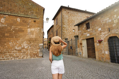 Holidays in italy. tourist woman visiting historic medieval town of orvieto, umbria, italy.