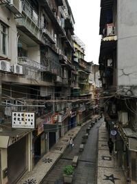 Street amidst buildings in city against sky