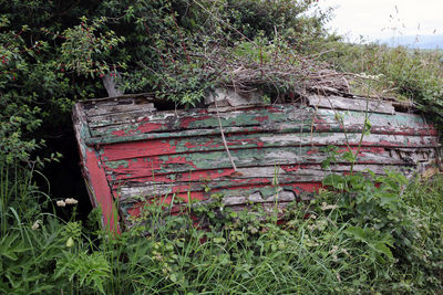 Abandoned wooden structure on field