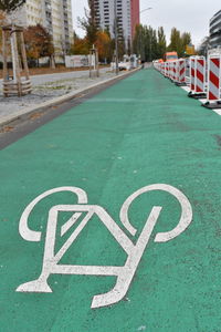 Close-up of text on road by building