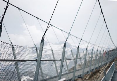 Panoramic view of sea against sky seen through fence