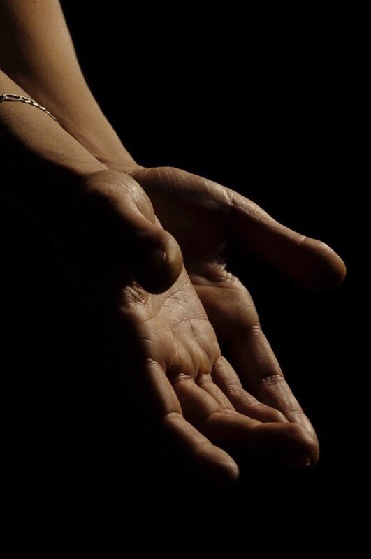 CLOSE UP OF WOMAN'S HAND OF HUMAN FEET