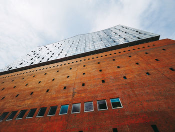 Low angle view of building against cloudy sky