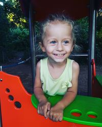 Portrait of a smiling girl sitting outdoors