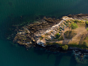 Aerial dron view of rocky peninsula with crystal clear turquoise water