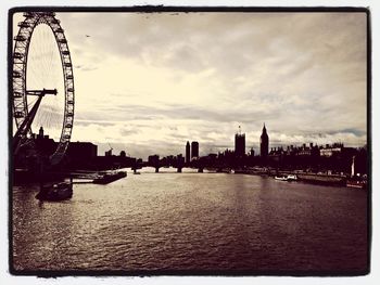 Ferris wheel against cloudy sky