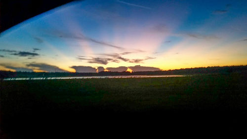 Scenic view of landscape against sky at sunset