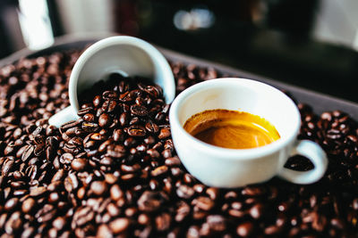 Close-up of coffee beans in cup on table