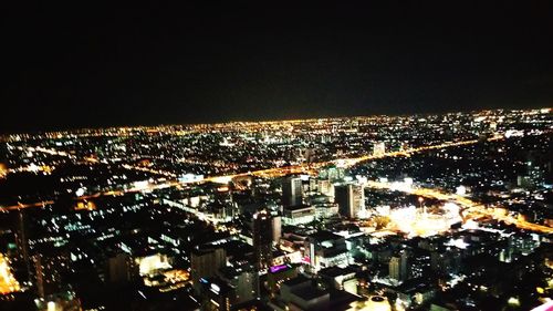 Aerial view of illuminated cityscape at night