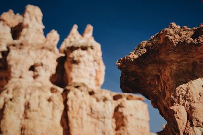 Low angle view of rock formation against sky