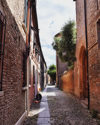 Alley amidst buildings against sky