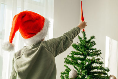 New year's and christmas. children are waiting for the holiday. child boy in a santa claus hat