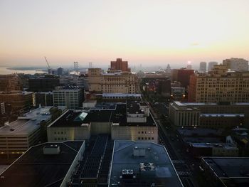 High angle view of buildings in city against sky during sunset