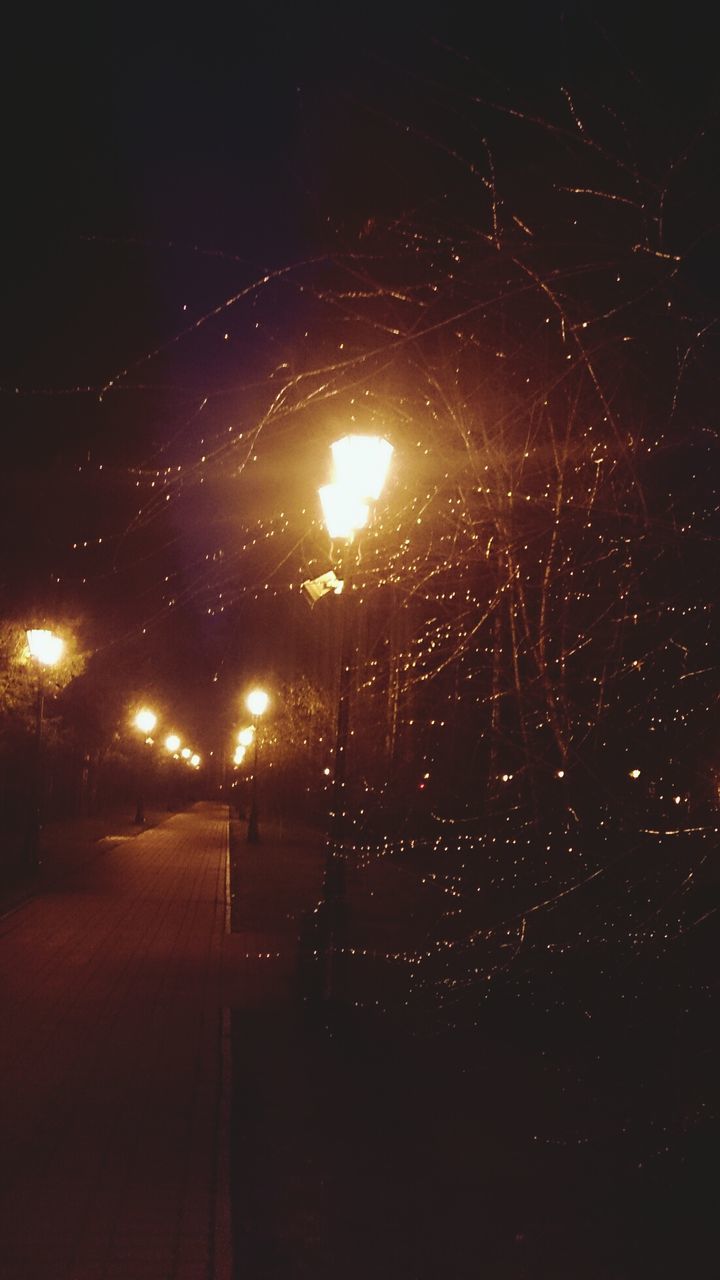 night, illuminated, street light, dark, lighting equipment, the way forward, sky, road, electricity, glowing, light - natural phenomenon, street, outdoors, no people, transportation, diminishing perspective, nature, light, low angle view, long exposure