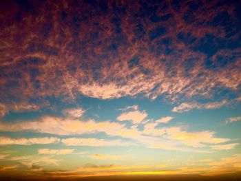 Low angle view of cloudy sky at sunset