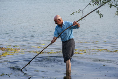 Full length of man fishing in sea