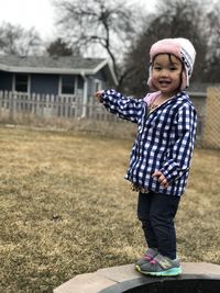 Portrait of cute girl standing on land