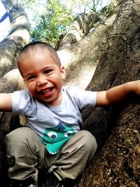 Portrait of boy sitting on rock