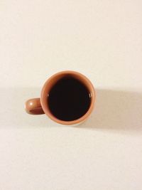 Directly above shot of coffee cup on white background