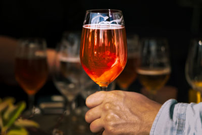 Close-up of man holding wineglass