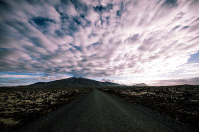 Road amidst landscape against sky