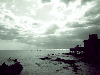 Scenic view of sea against cloudy sky