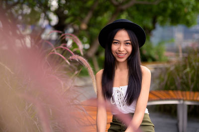 Portrait of a smiling young woman standing outdoors