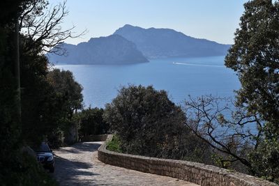 Scenic view of sea and mountains against clear sky