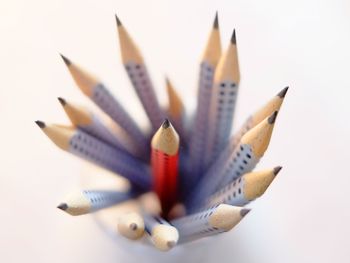 Close-up of colored pencils against white background