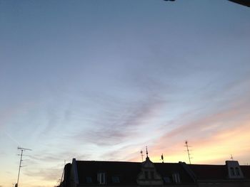 High section of building against sky at sunset