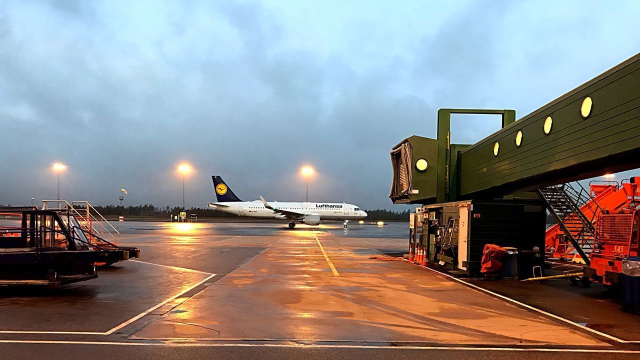 AIRPLANE ON AIRPORT RUNWAY AGAINST SKY