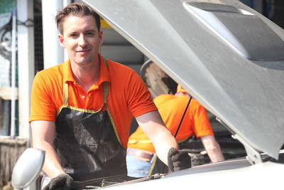 Portrait of man working in car