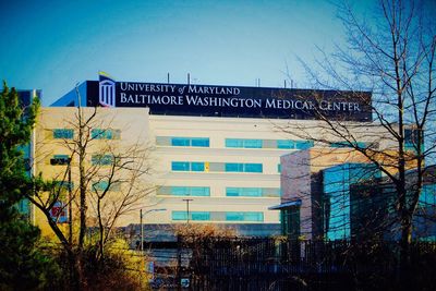 Low angle view of buildings against clear blue sky