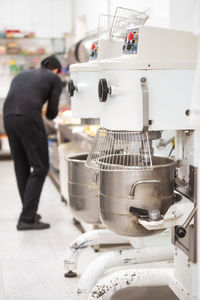 Rear view of man working in kitchen