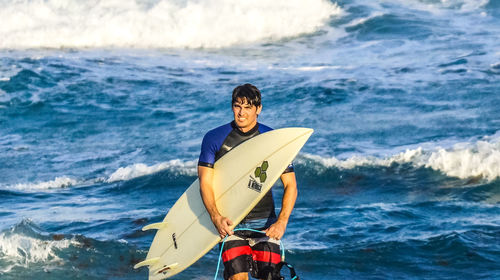 Young man standing in sea