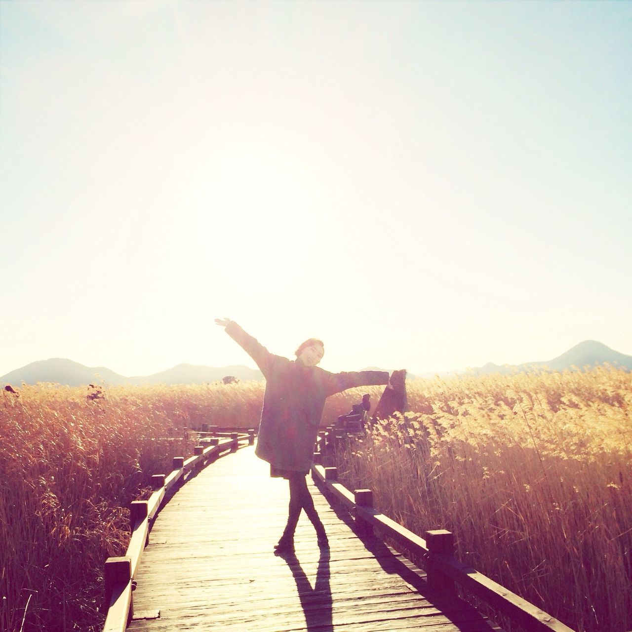 clear sky, copy space, lifestyles, leisure activity, full length, sunlight, landscape, standing, person, sky, men, tranquility, nature, mountain, sunbeam, day, desert, sun