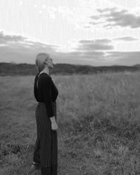 Rear view of woman standing on field